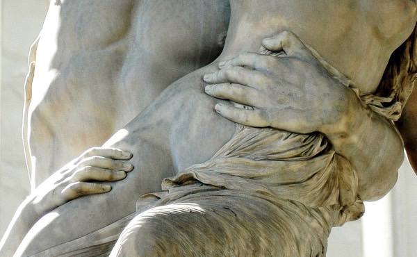 a marble sculpture of a man embracing gently a beautiful woman which symbolises their intimate connection.